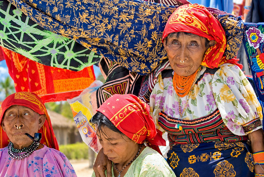 Guna women in traditional dress and molas at an island market in San Blas