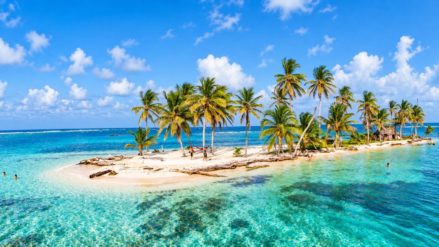 Aerial view of a palm-fringed deserted island in San Blas