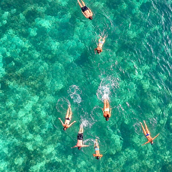 Aerial view of travelers snorkeling over a shallow reef